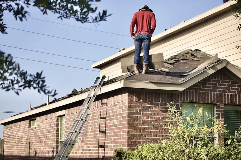 Professional roofer working on a residential roof in Pinewood Vista